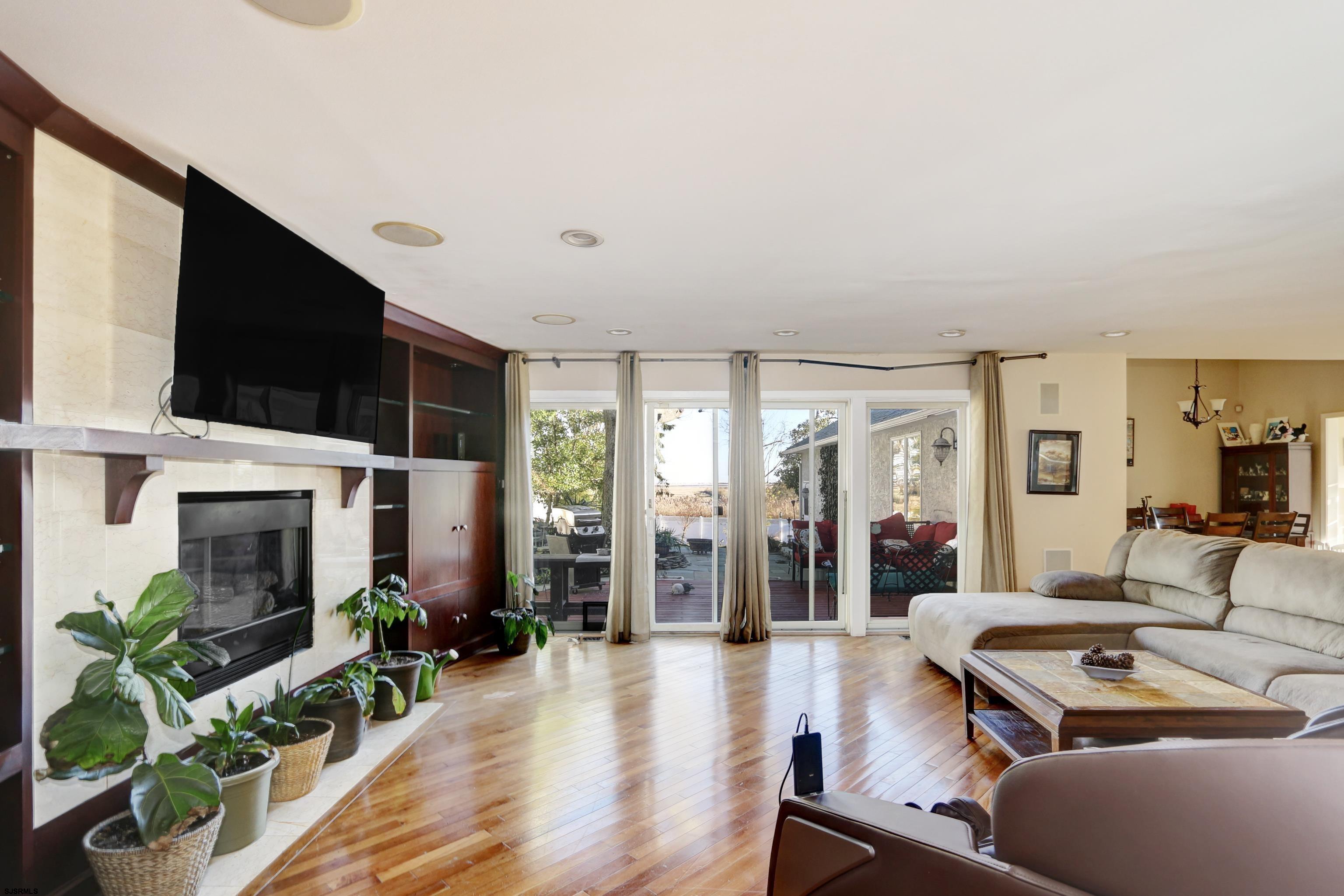 1860 Franklin Boulevard Linwood, NJ 08221 - Photo 6 of 39 a living room with furniture a flat screen tv and a fireplace