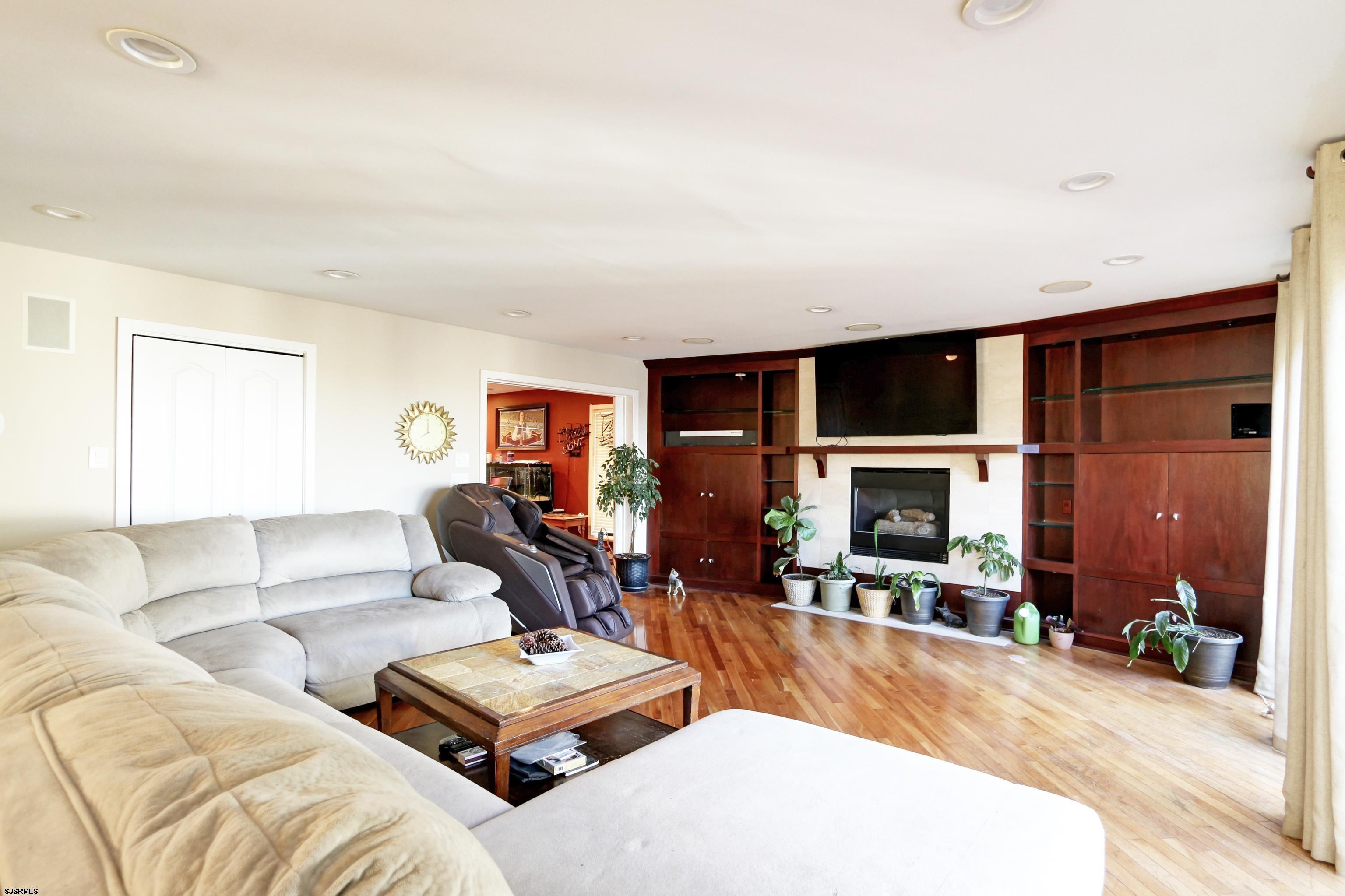 1860 Franklin Boulevard Linwood, NJ 08221 - Photo 7 of 39 a living room with furniture a fireplace and a flat screen tv
