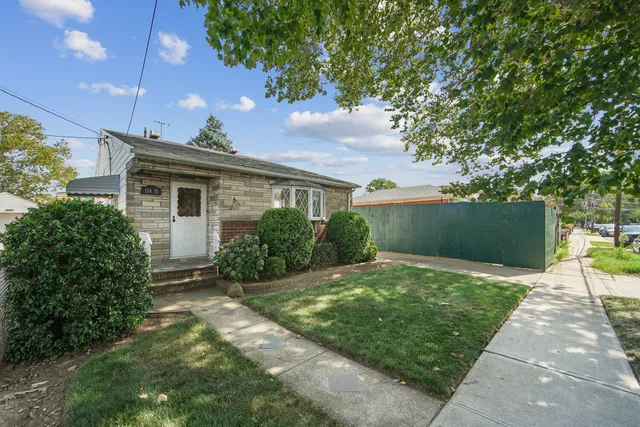 a backyard of a house with plants and trees