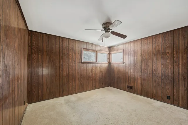 a view of a livingroom with a chandelier fan