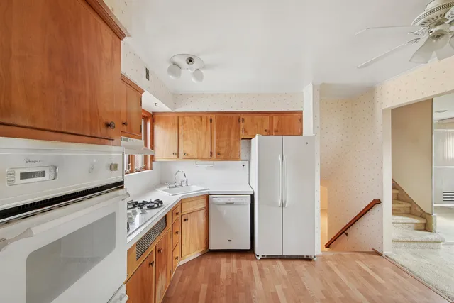 a kitchen with a white cabinets and white appliances