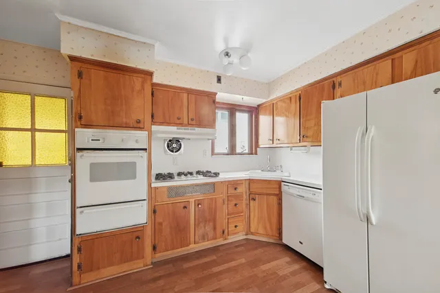 a kitchen with a sink a refrigerator and window