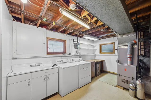 a utility room with cabinets dryer and washer
