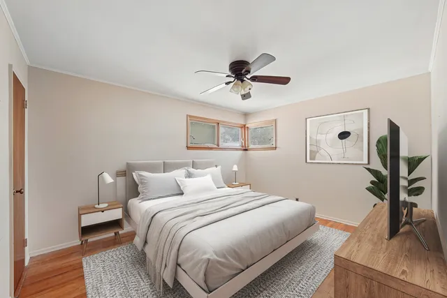 a bedroom with a large bed and a flat tv screen on a dresser