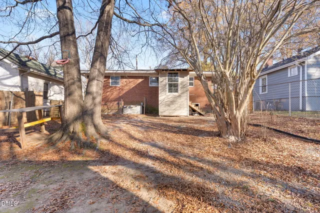 a view of a yard covered with snow in front of house