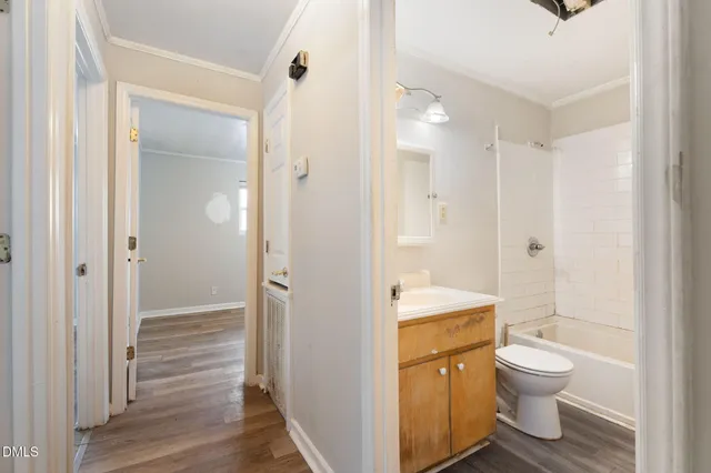 a bathroom with a granite countertop toilet a sink and a shower