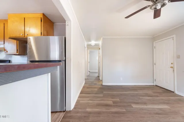 a view of a hallway with wooden floor and staircase