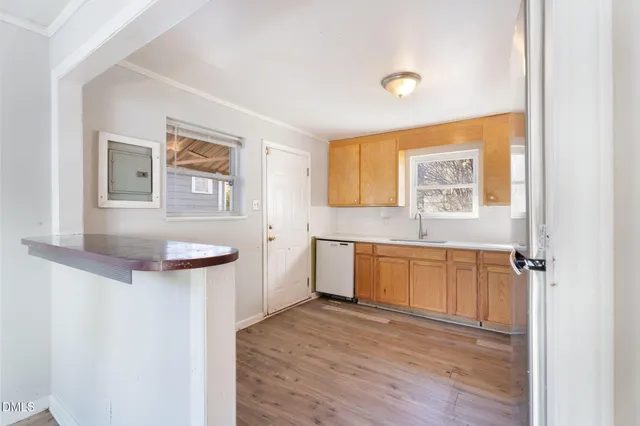 a kitchen with a refrigerator and window