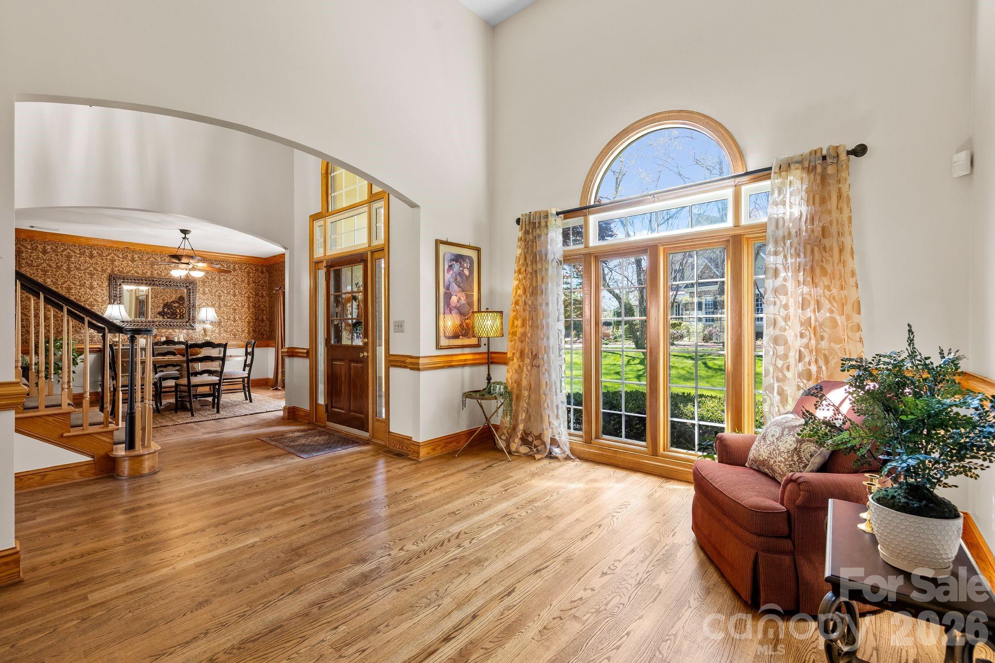 3530 Cardiff Lane Matthews, NC 28104 - Photo 10 of 39 a living room with furniture a flat screen tv and floor to ceiling windows