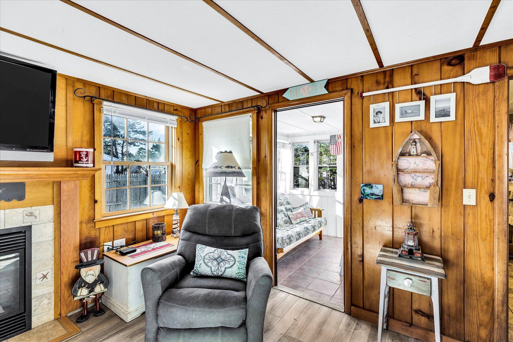 22 Edwards Road Dennis Port, MA 02639 - Photo 22 of 40 a living room with furniture a fireplace and a flat screen tv