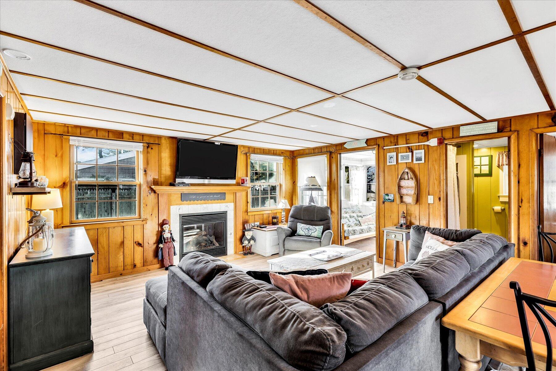 22 Edwards Road Dennis Port, MA 02639 - Photo 24 of 40 a living room with fireplace furniture and a floor to ceiling window