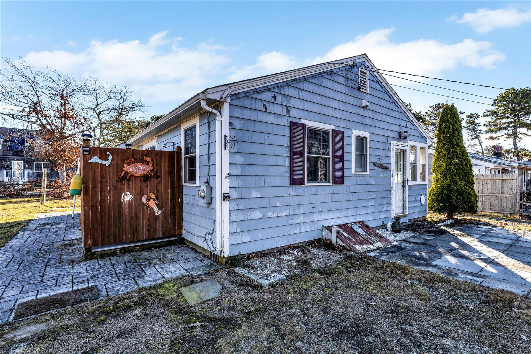 22 Edwards Road Dennis Port, MA 02639 - Photo 3 of 40 a view of a wooden house with a yard