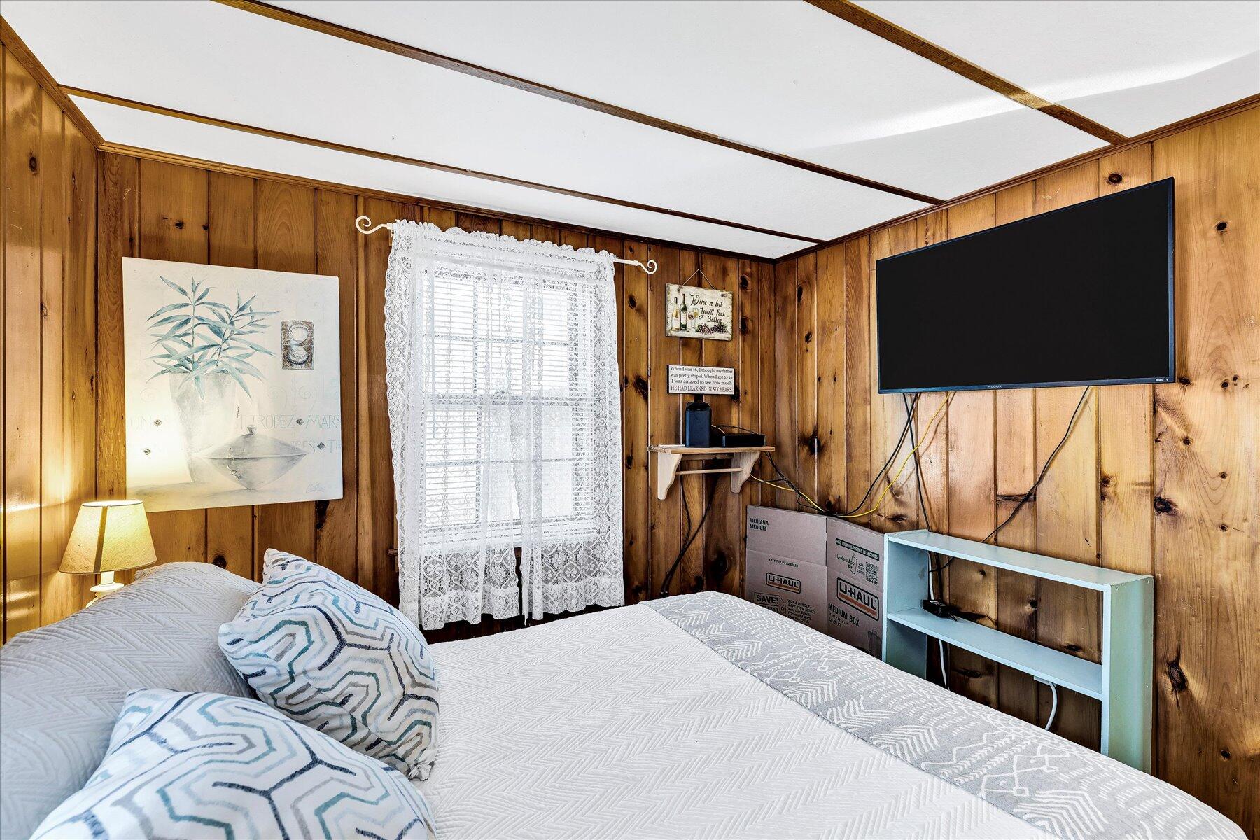 22 Edwards Road Dennis Port, MA 02639 - Photo 35 of 40 a bedroom with a bed and a flat screen tv