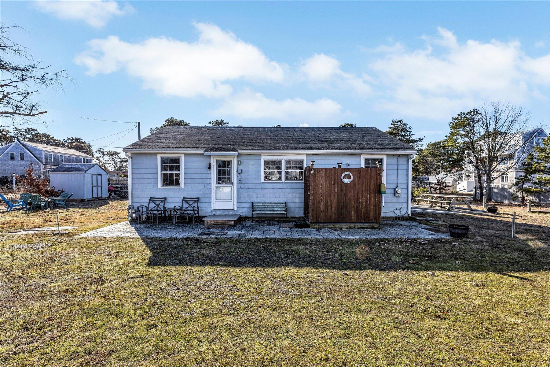 22 Edwards Road Dennis Port, MA 02639 - Photo 9 of 40 a view of a house with a yard covered with snow