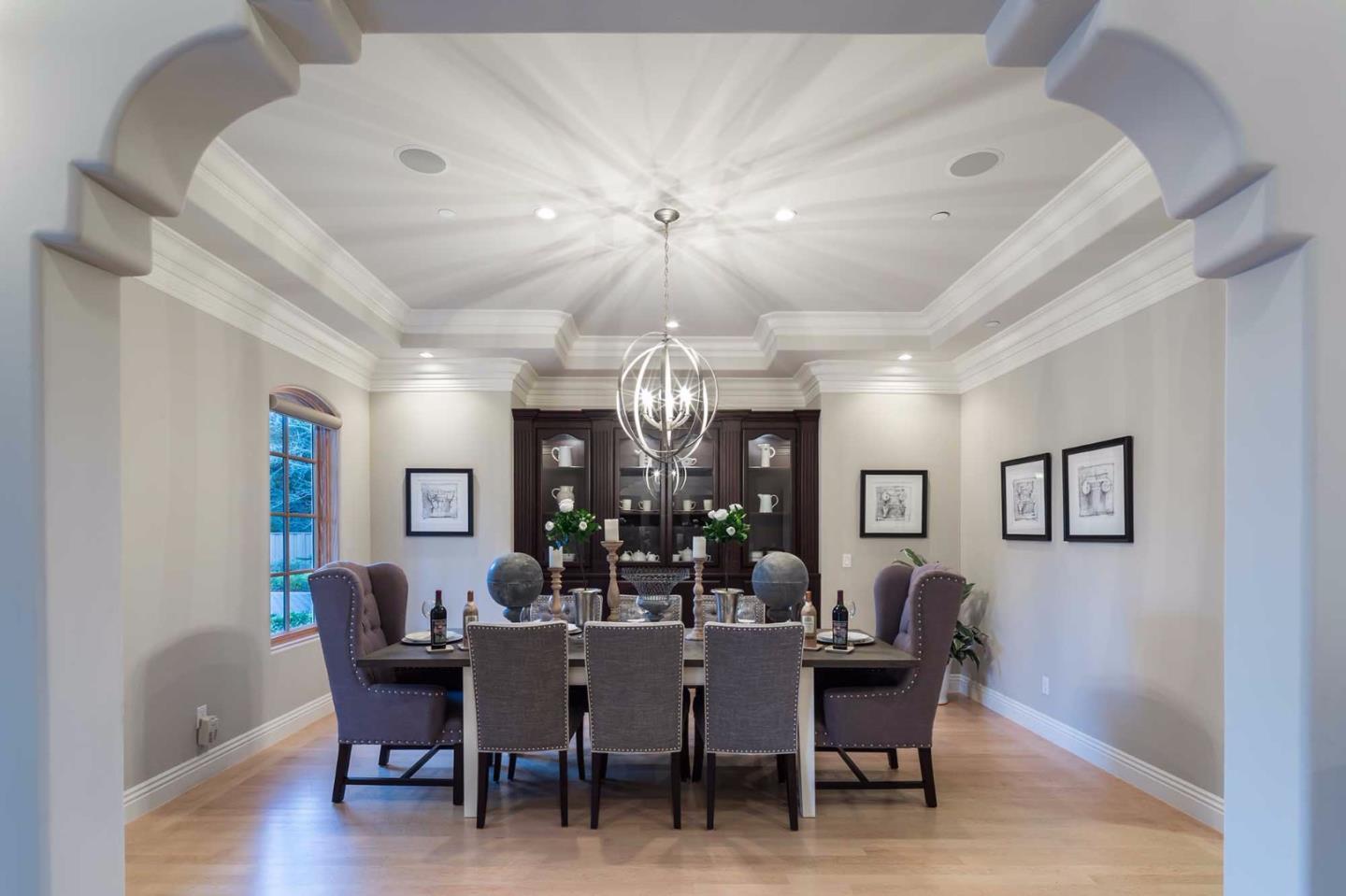 84 Nora Way Atherton, CA 94027 - Photo 8 of 37 a dining room with wooden floor a chandelier fan a wooden table and chairs