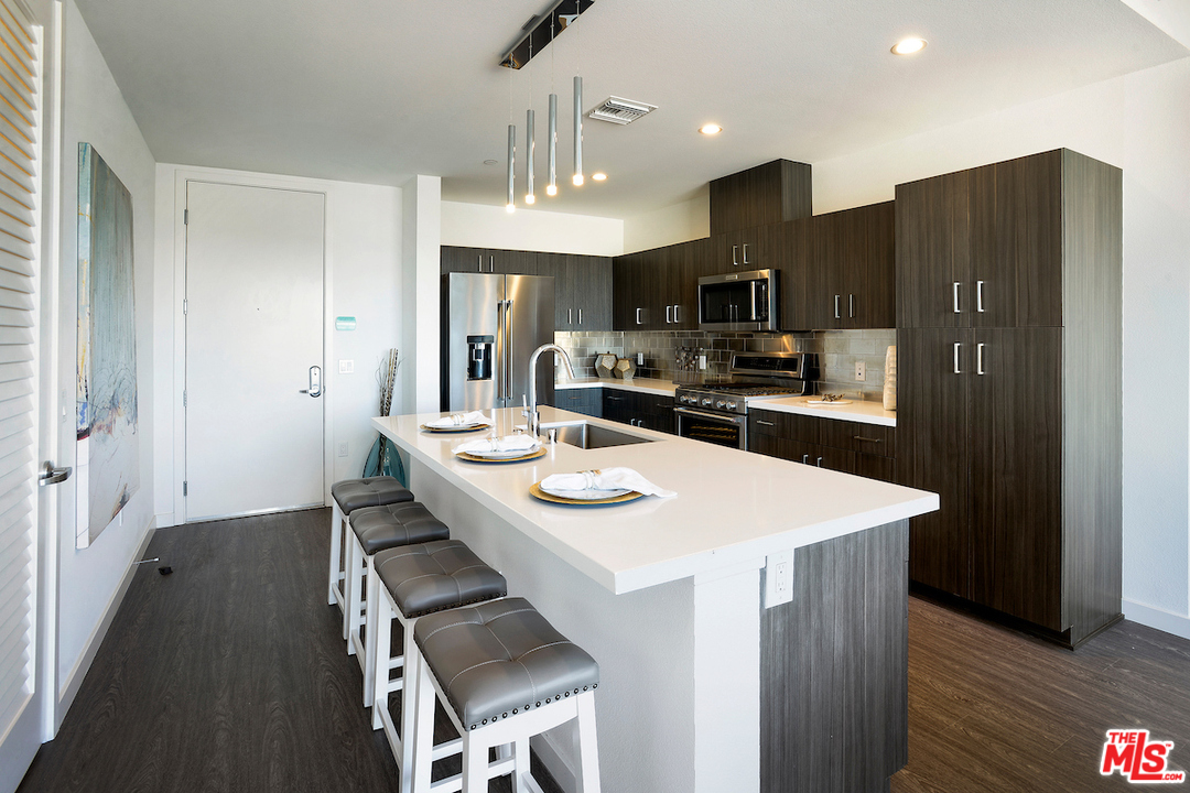 4140 Glencoe Avenue, Unit 604 Marina del Rey, CA 90292 - Photo 3 of 20 a kitchen with stainless steel appliances a sink stove refrigerator and cabinets