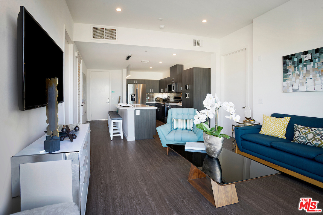 4140 Glencoe Avenue, Unit 604 Marina del Rey, CA 90292 - Photo 5 of 20 a living room with furniture kitchen view and a flat screen tv