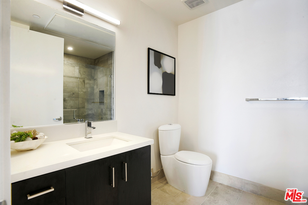 4140 Glencoe Avenue, Unit 604 Marina del Rey, CA 90292 - Photo 7 of 20 a bathroom with a toilet a sink and mirror
