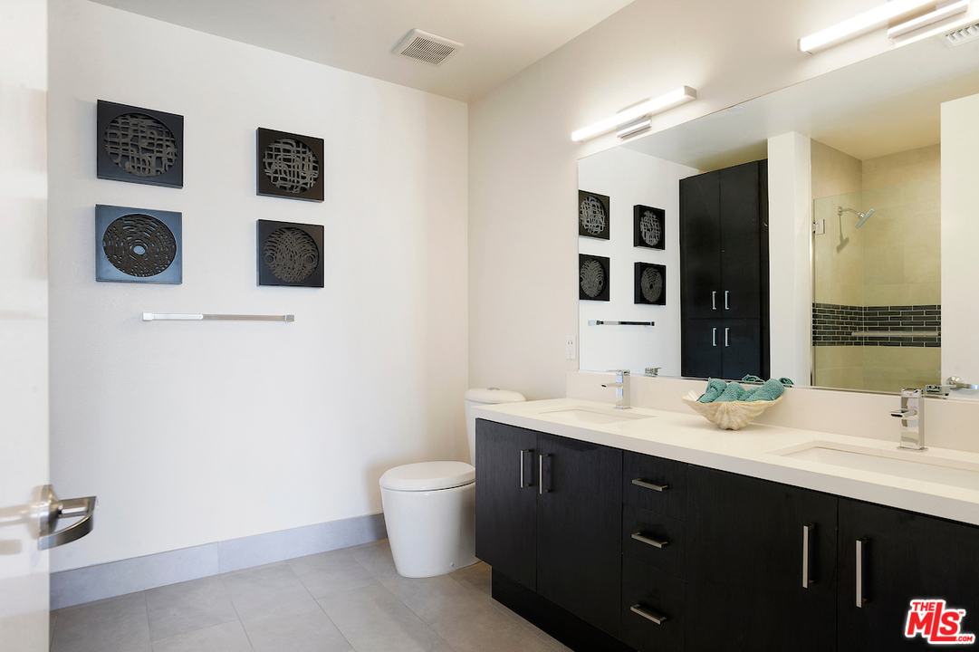 4140 Glencoe Avenue, Unit 604 Marina del Rey, CA 90292 - Photo 9 of 20 a bathroom with a double vanity sink and a mirror
