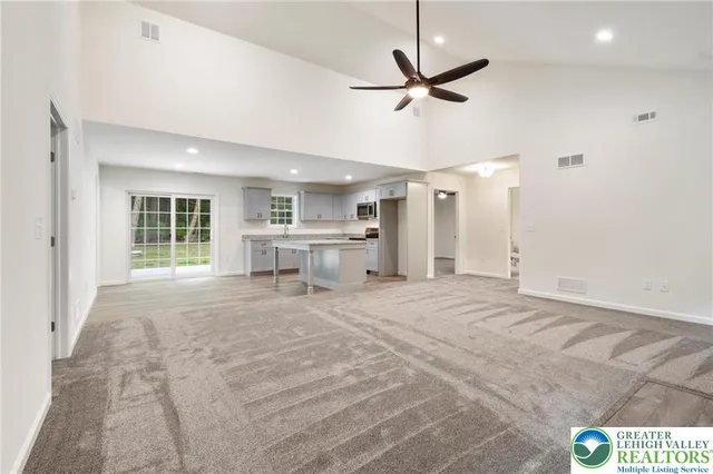 a view of a livingroom with a ceiling fan and window