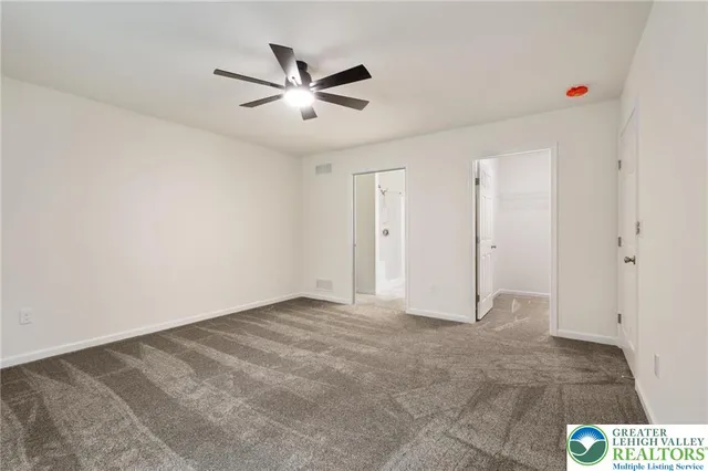 a bathroom with a granite countertop toilet and a shower