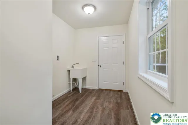 an empty room with a ceiling fan and a window