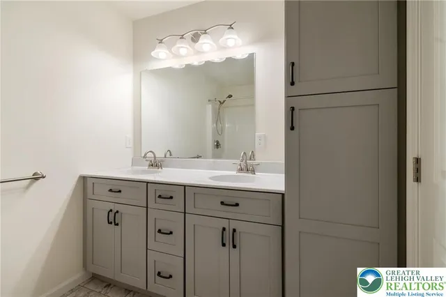 a bathroom with a double vanity sink and mirror