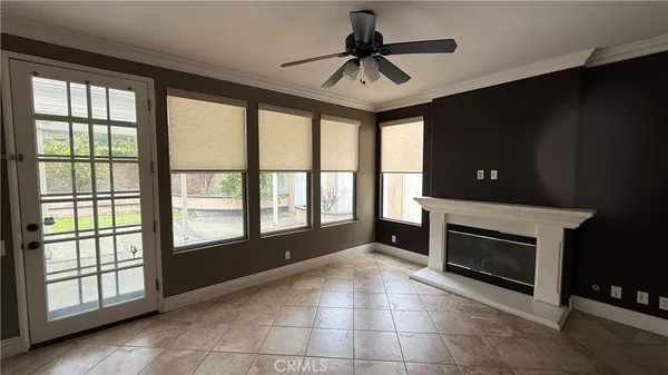 a view of an empty room with a fireplace and a window