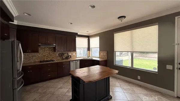 a kitchen with stainless steel appliances granite countertop a sink counter space and a window