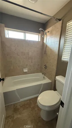 a bathroom with a toilet a sink and bathtub