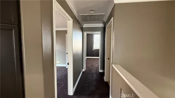 a view of hallway with wooden floor