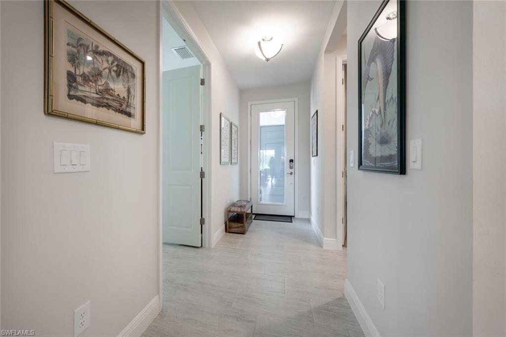 2247 Marquesa Circle Naples, FL 34112 - Photo 14 of 27 a view of a hallway with paintings on the wall
