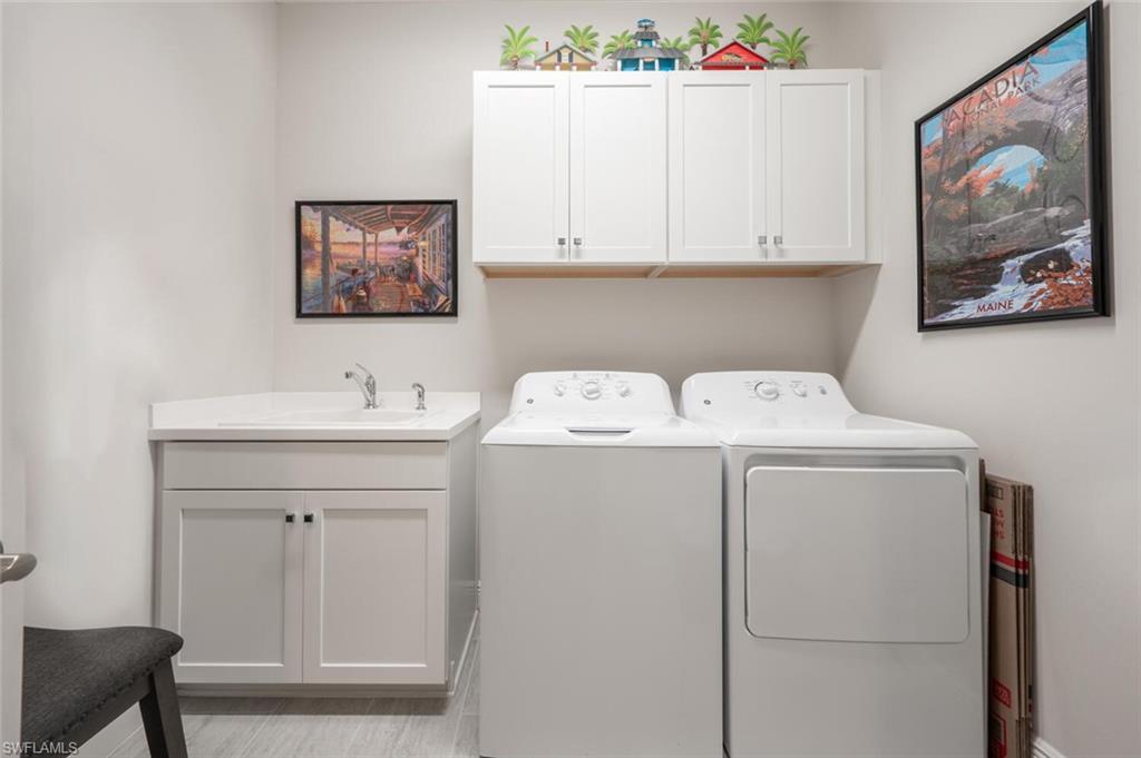 2247 Marquesa Circle Naples, FL 34112 - Photo 16 of 27 a utility room with dryer and washer