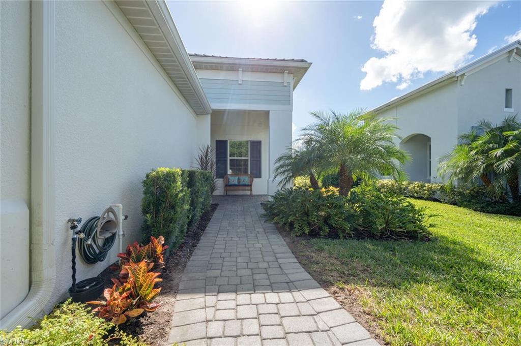 2247 Marquesa Circle Naples, FL 34112 - Photo 21 of 27 a front view of a house with garden
