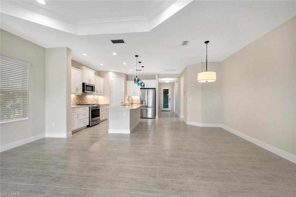 2247 Marquesa Circle Naples, FL 34112 - Photo 8 of 27 a view of an empty room and kitchen view