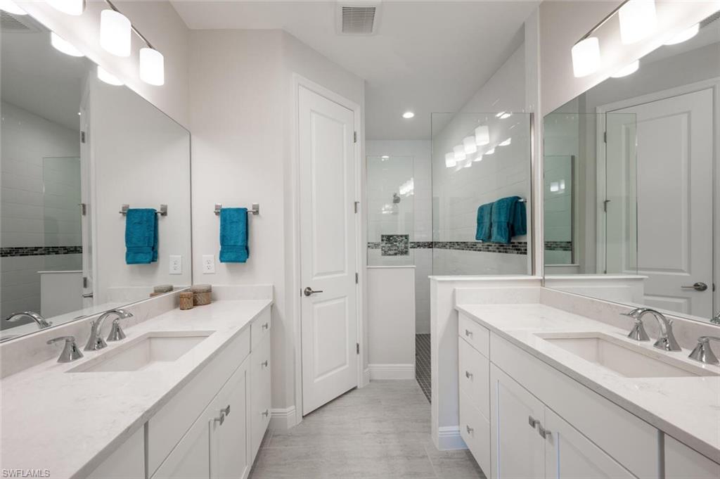 2247 Marquesa Circle Naples, FL 34112 - Photo 10 of 27 a bathroom with 2 sink and a mirror