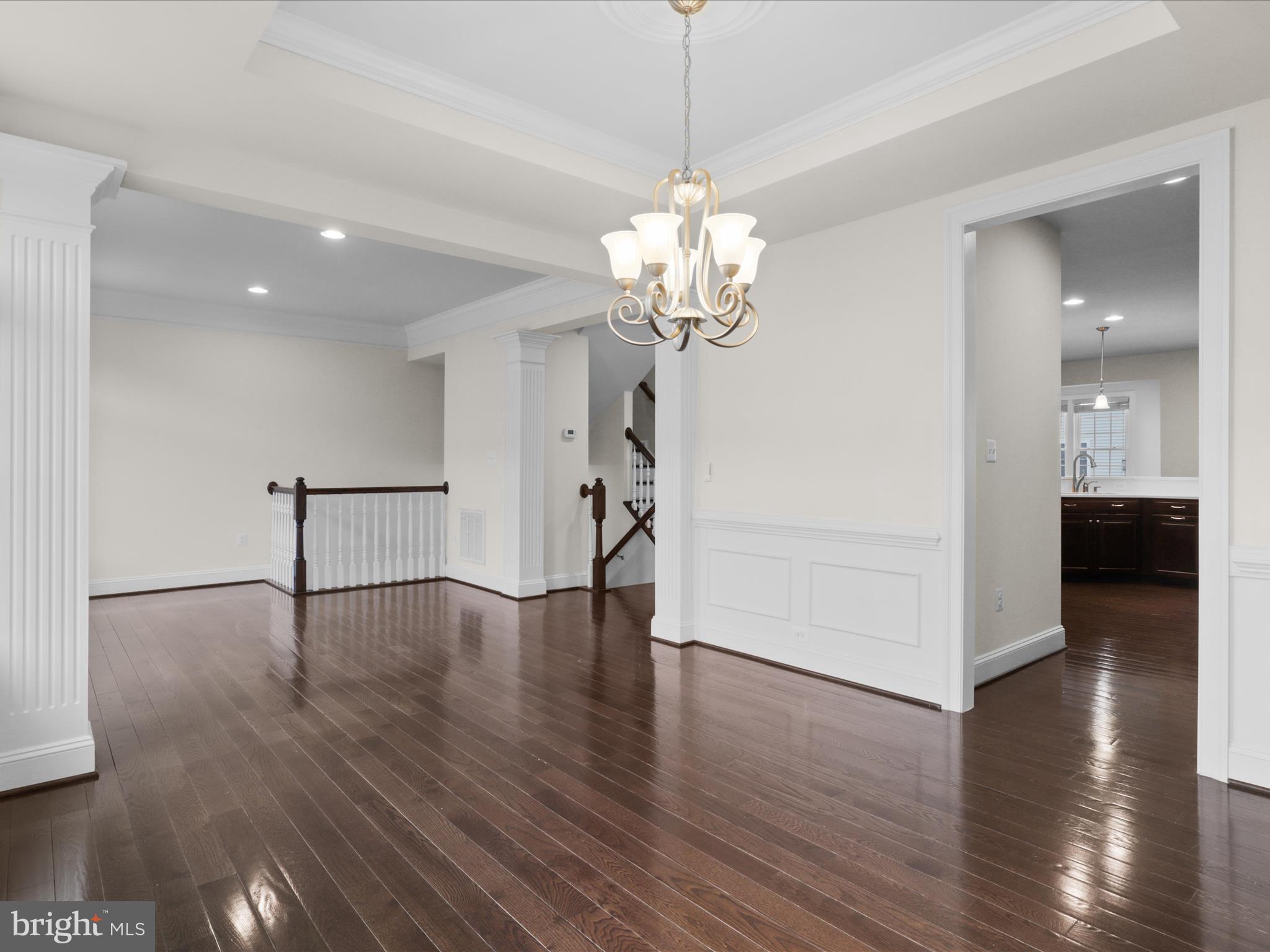 25138 Earlsdon Terrace Chantilly, VA 20152 - Photo 14 of 54 a view of a livingroom with wooden floor and a chandelier