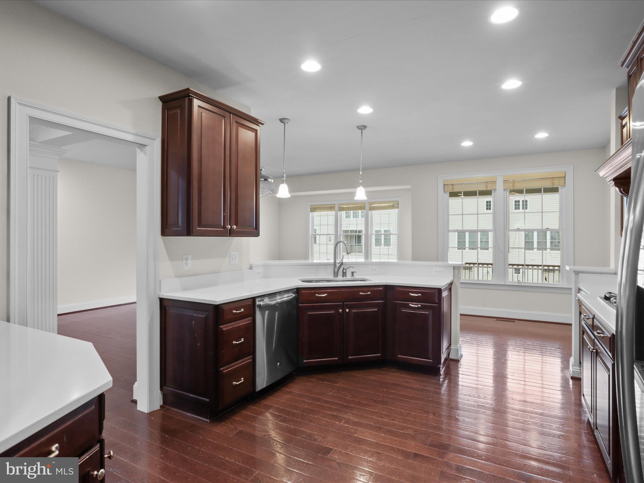 25138 Earlsdon Terrace Chantilly, VA 20152 - Photo 18 of 54 a large kitchen with wooden cabinets and a wooden floor