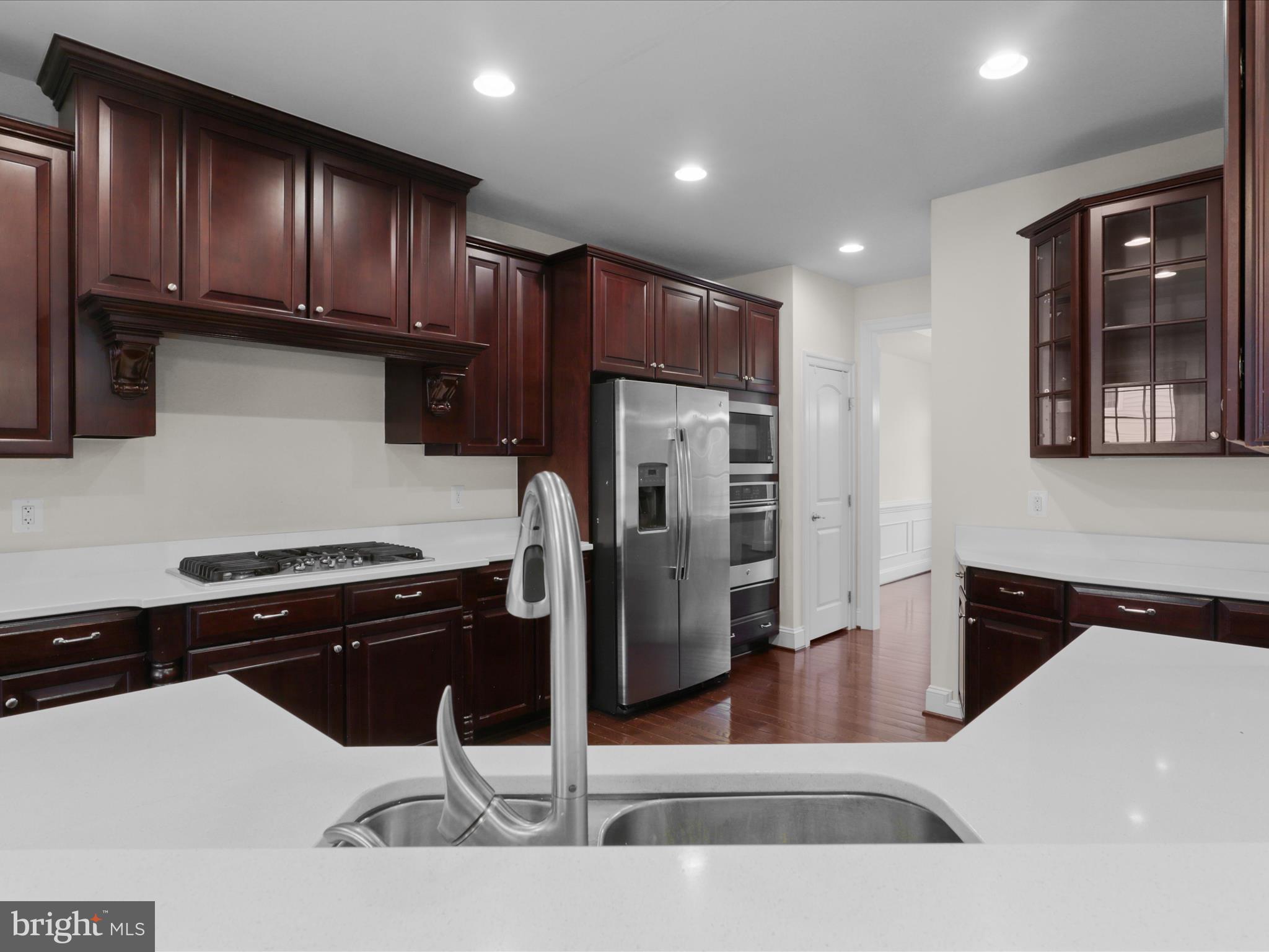 25138 Earlsdon Terrace Chantilly, VA 20152 - Photo 22 of 54 a kitchen with stainless steel appliances granite countertop a refrigerator and a stove top oven