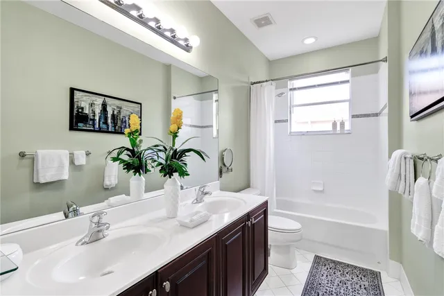 a bathroom with a tub a sink and a large mirror
