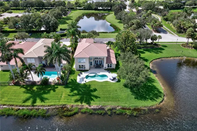 an aerial view of a house with garden space and lake view