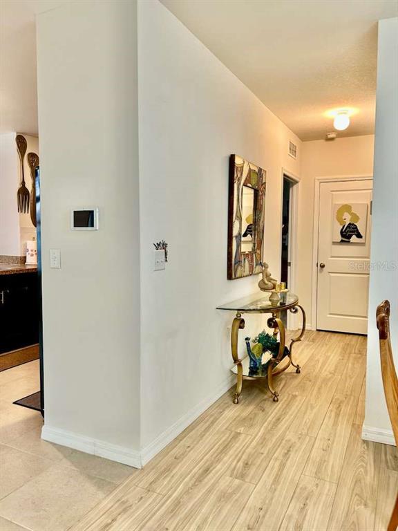 10214 Mangrove Well Road Sun City Center, FL 33573 - Photo 16 of 23 a view of a room with wooden floor and furniture