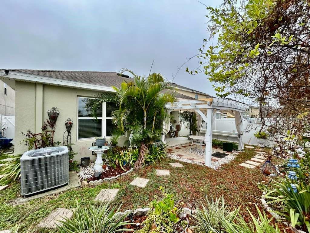 10214 Mangrove Well Road Sun City Center, FL 33573 - Photo 20 of 23 a front view of a house with garden