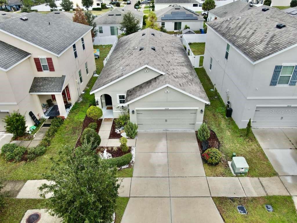 10214 Mangrove Well Road Sun City Center, FL 33573 - Photo 3 of 23 an aerial view of multiple houses with a yard