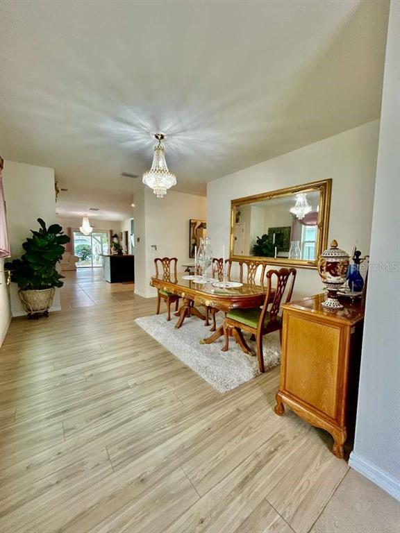 10214 Mangrove Well Road Sun City Center, FL 33573 - Photo 6 of 23 a living room with furniture and a flat screen tv