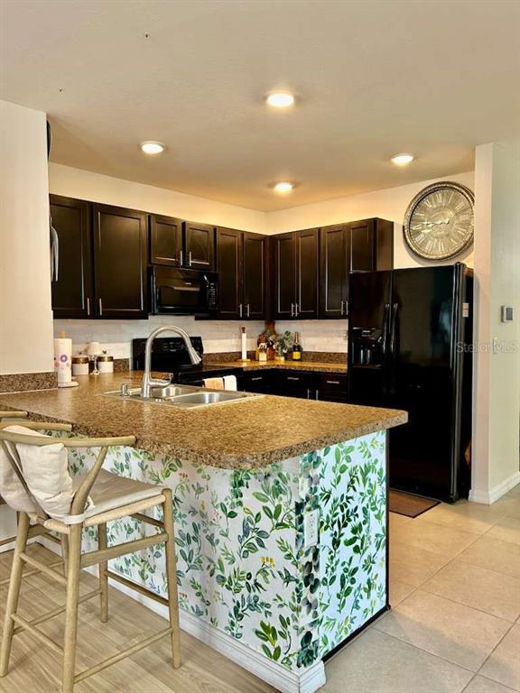 10214 Mangrove Well Road Sun City Center, FL 33573 - Photo 9 of 23 a kitchen with stainless steel appliances granite countertop a stove top oven a sink a counter top space and cabinets