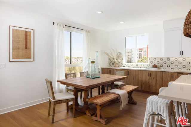 a view of a dining room with furniture window and wooden floor
