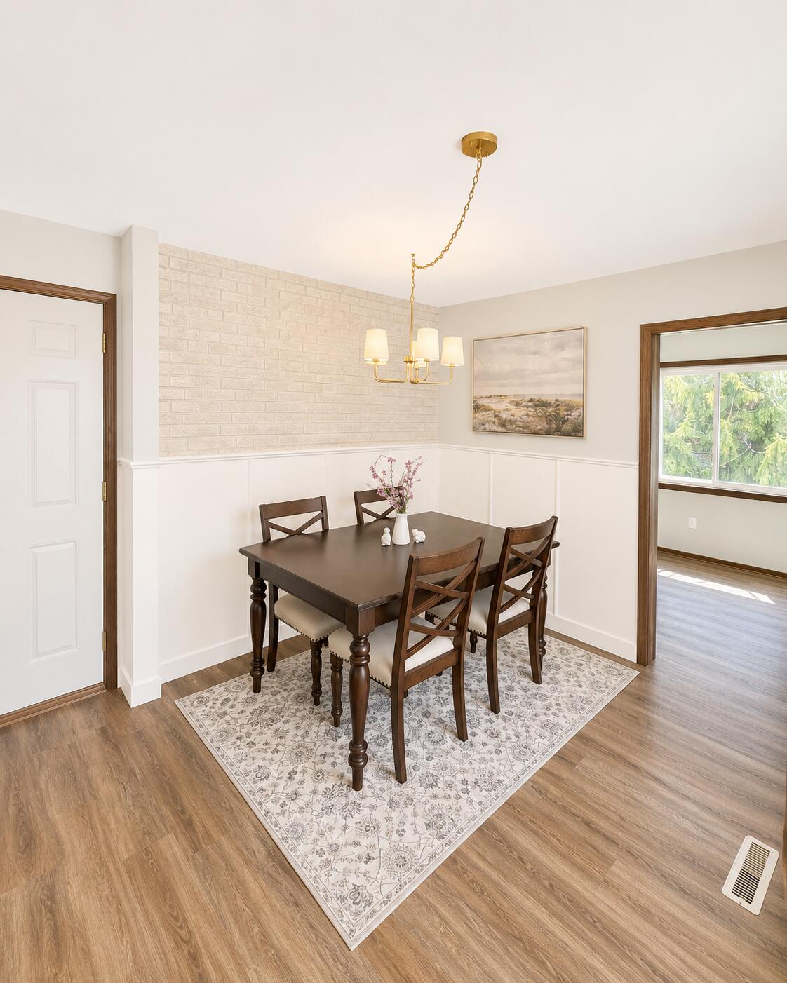 726 Royal Park Road Caledonia, WI 53402 - Photo 16 of 29 Stylish dining area featuring updated lighting, custom wainscoting, textured accent wall, and warm natural tones—perfect for everyday living or entertaining guests.