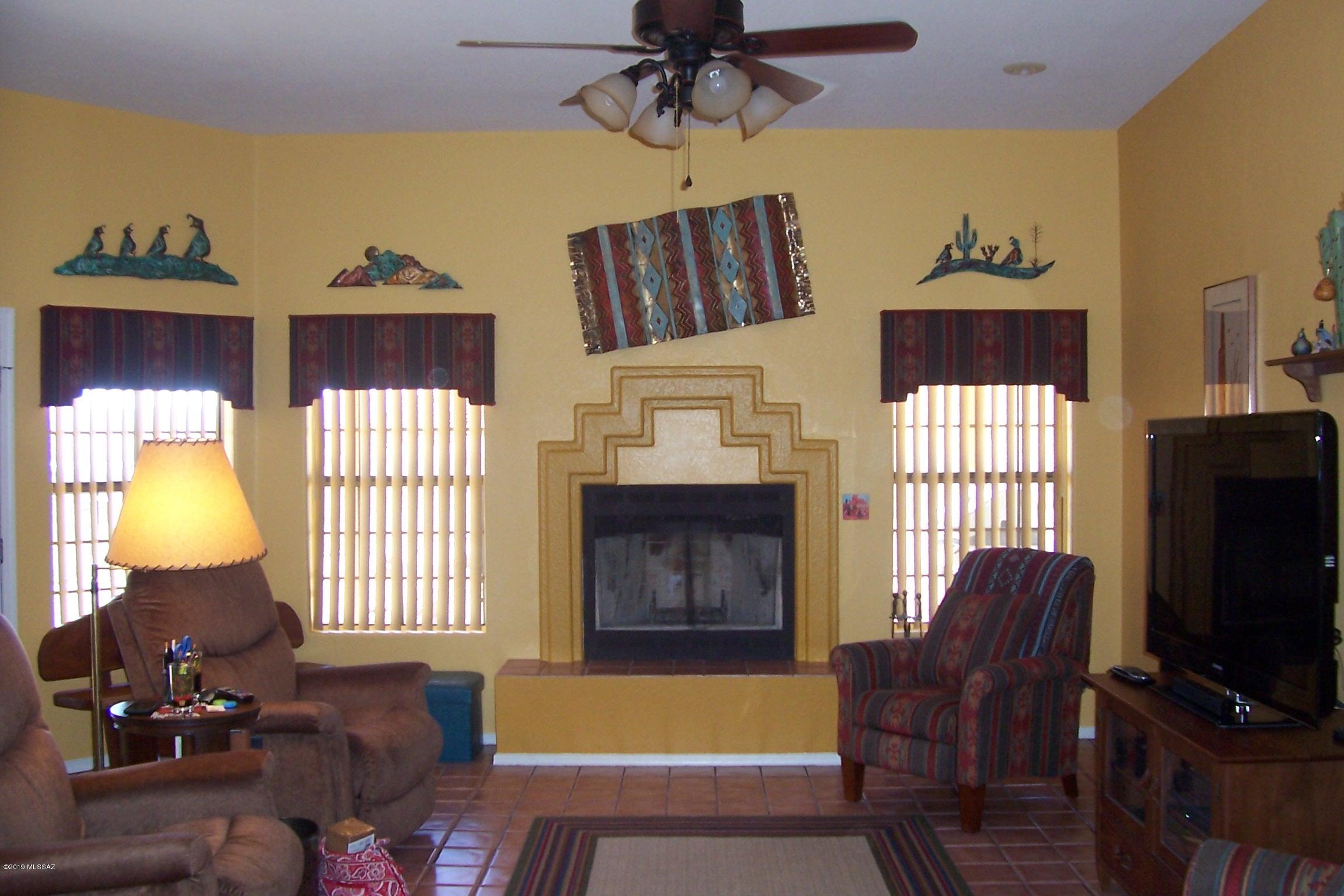 1256 Avenida Gloriosa Rio Rico, AZ 85648 - Photo 5 of 25 a living room with furniture a window and a flat screen tv