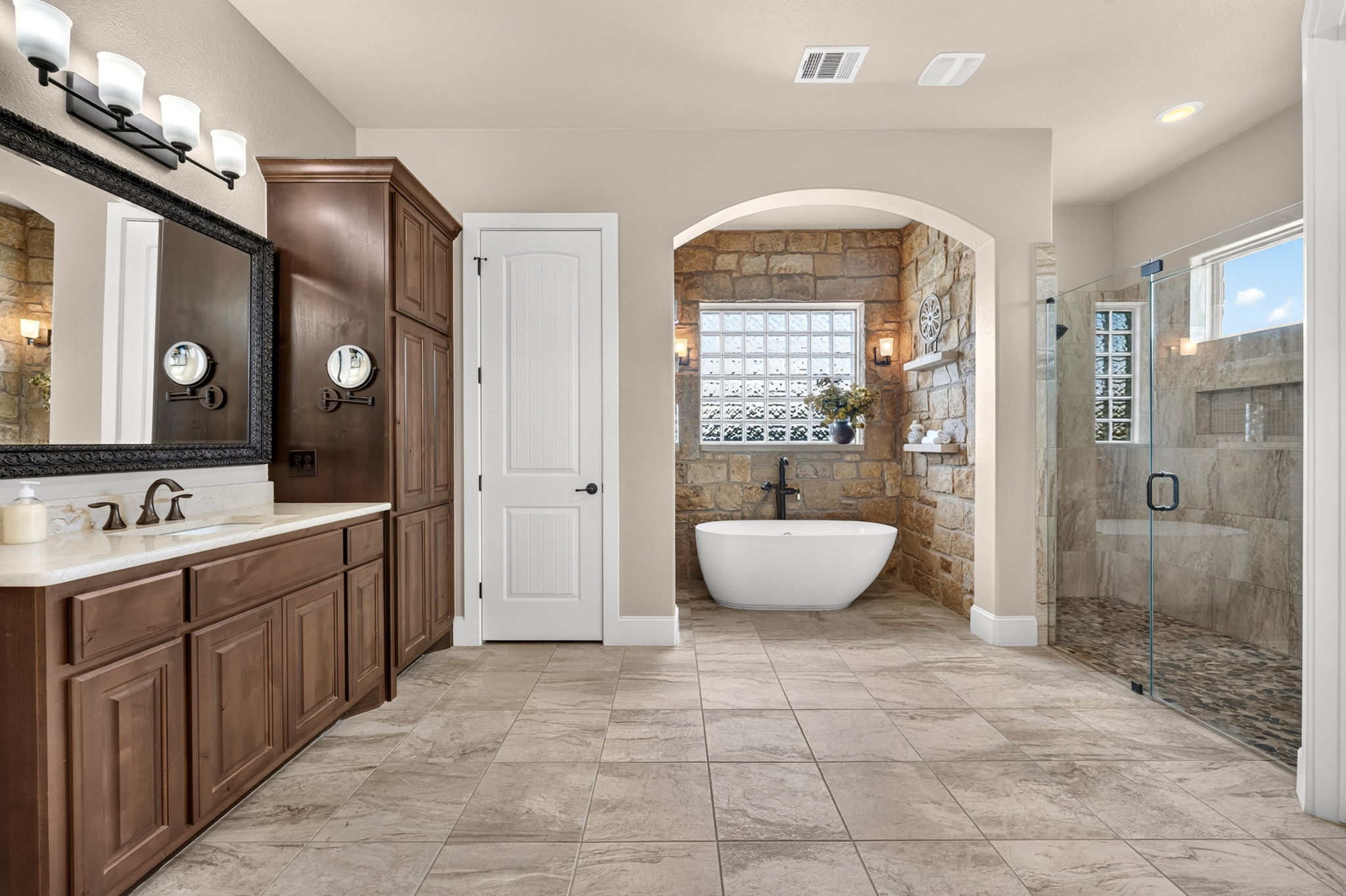 105 Coopers Hill Road Georgetown, TX 78633 - Photo 21 of 40 a spacious bathroom with a granite countertop sink a toilet a mirror and shower